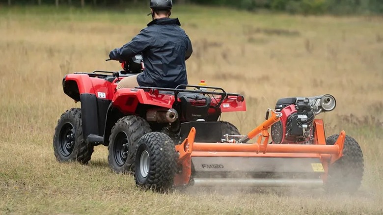 A Chapman flail mower towed by an ATV.