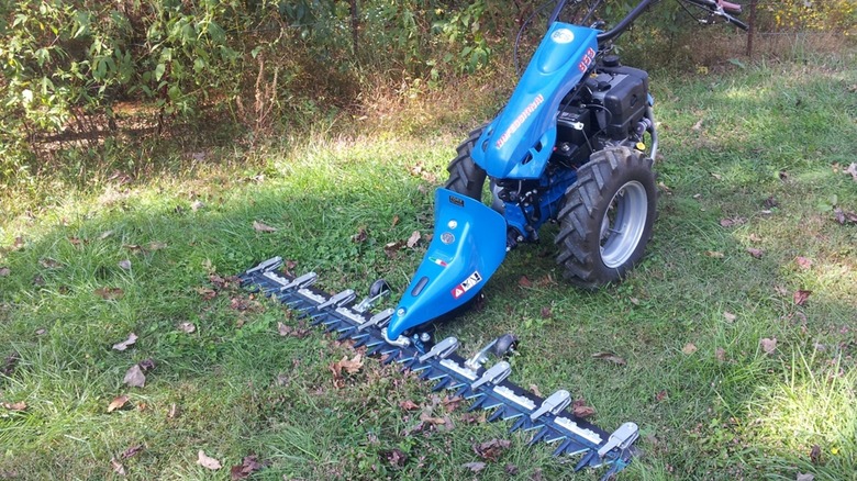 A BCS push-style sickle bar mower on grass.