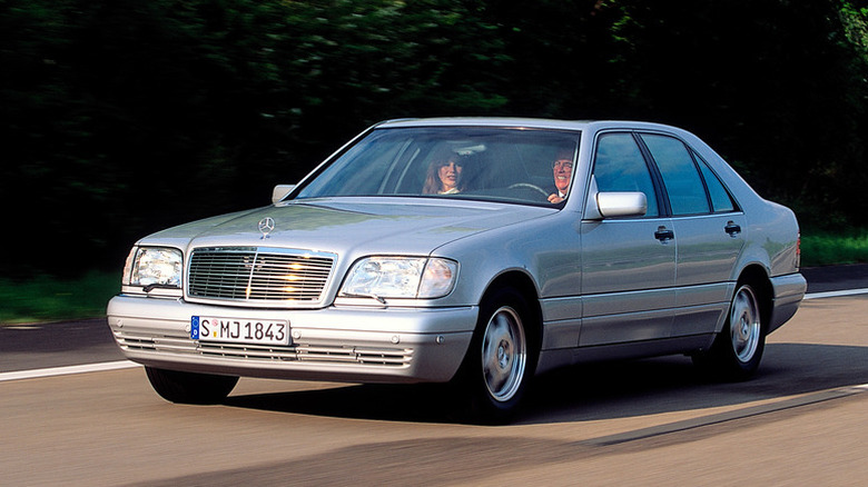 Silver metallic 1991 Mercedes-Benz S-Class driving on a public road