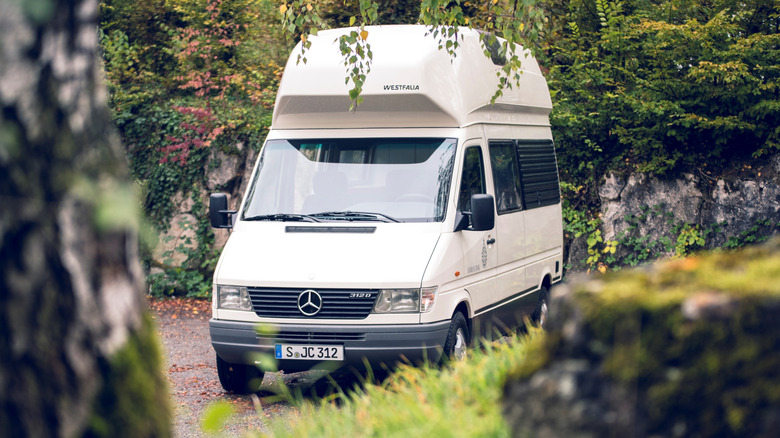 Mercedes-Benz Sprinter camper van front 3/4 view parked in nature