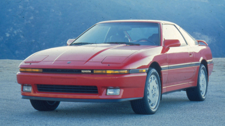 A red 1987 Toyota Supra Turbo parked on flat ground.