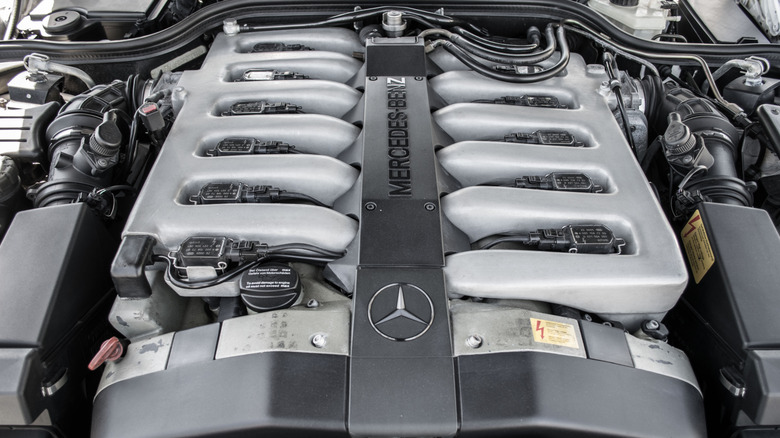 Mercedes M120 engine on display under the open hood of R129 SL600