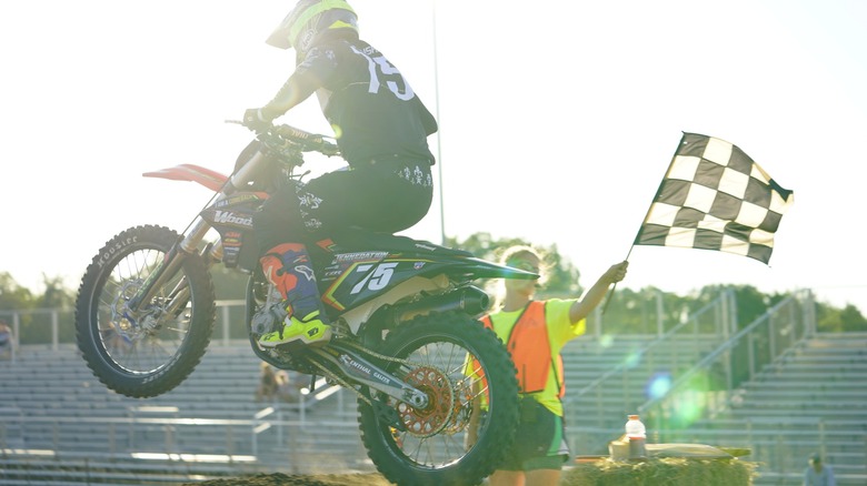 Dirt bike racer crossing the finish line