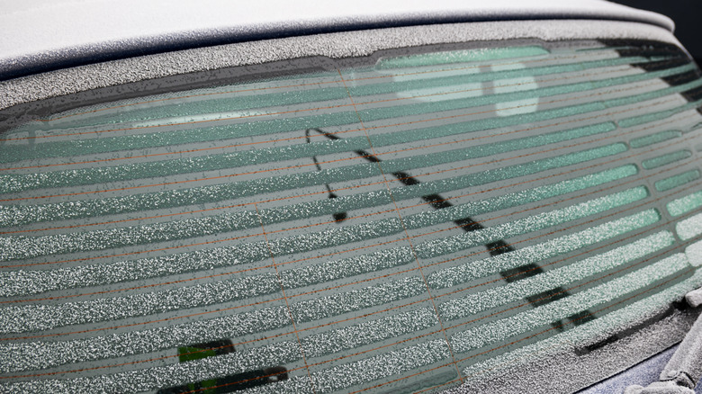 Close-up view of horizontal window defroster lines on a car's rear windshield