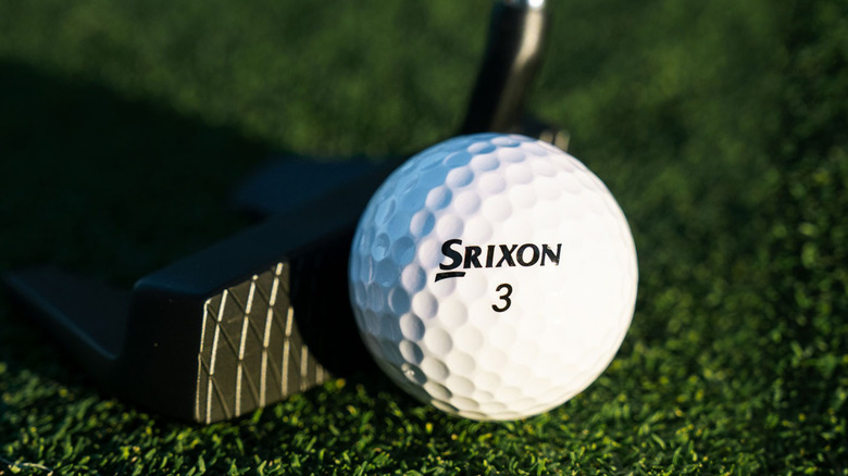 Golf club striking Srixon golf ball