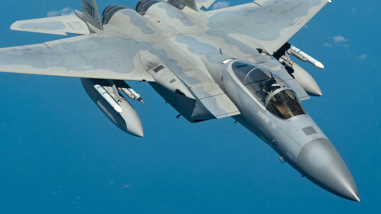An F-15 flying through a blue sky
