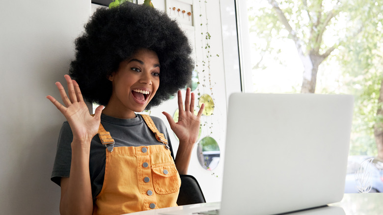 person excited at laptop