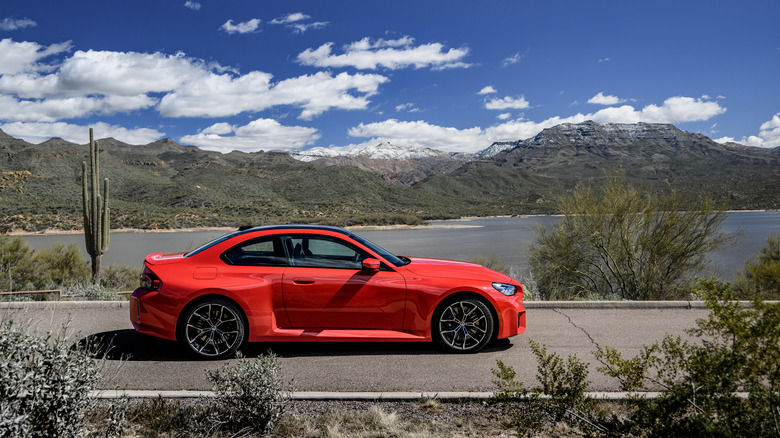 2023 BMW M2 coupe in bright red from profile