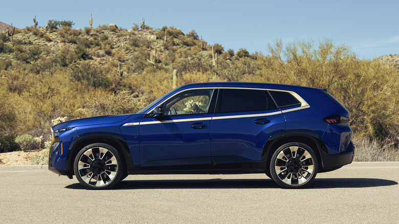 2023 BMW XM in blue with gold trim, profile view