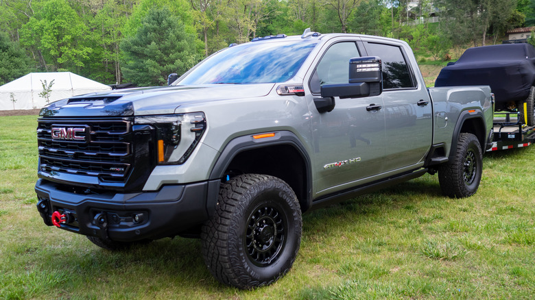 2024 GMC Sierra HD AT4X AEV Extreme Edition parked with mystery friend in tow