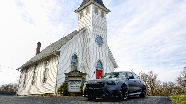 BMW M5 in front of church