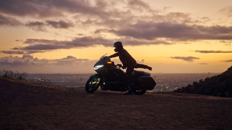 a rider hopping on a Honda Goldwing