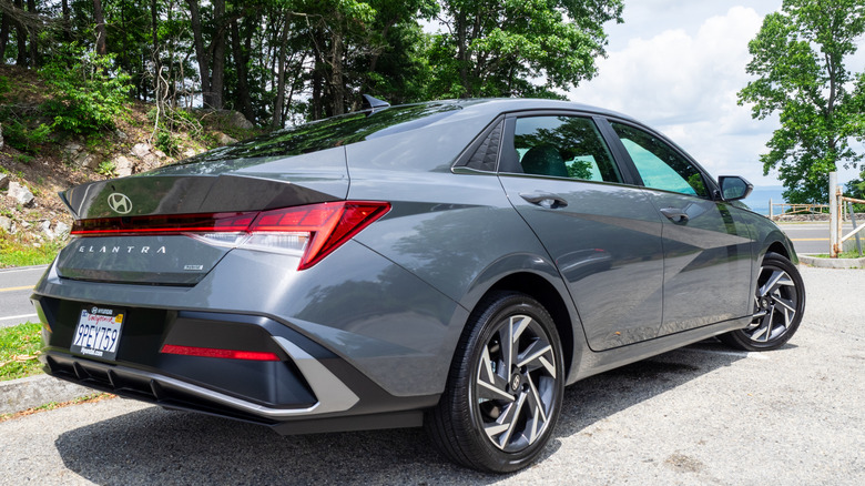 2025 Hyundai Elantra Hybrid parked next to a mountain road