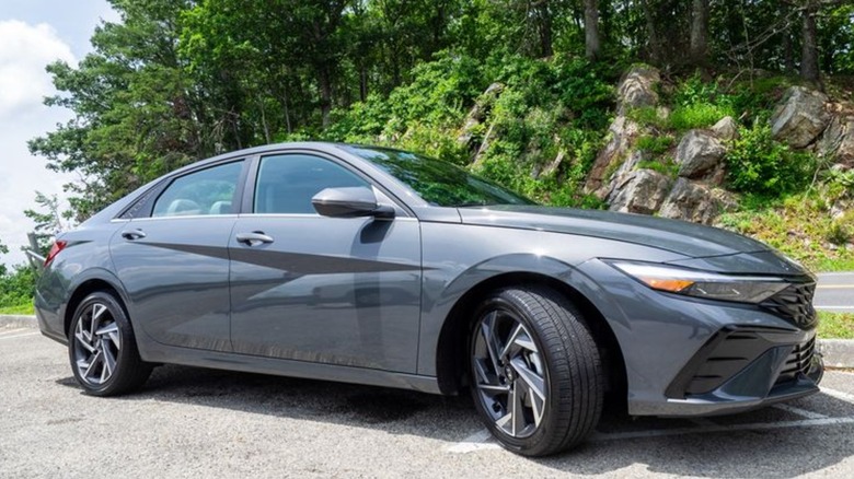 2025 Hyundai Elantra Hybrid parked next to a mountain road
