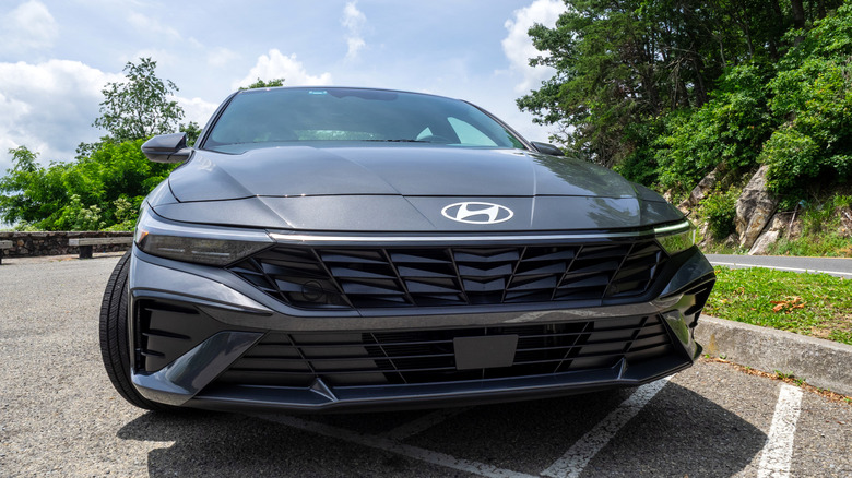 2025 Hyundai Elantra Hybrid parked next to a mountain road