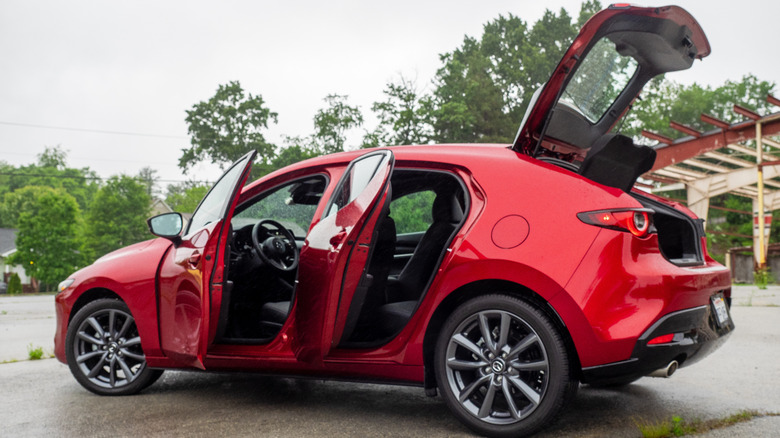 2025 Mazda3 Hatchback parked with doors and rear hatch open