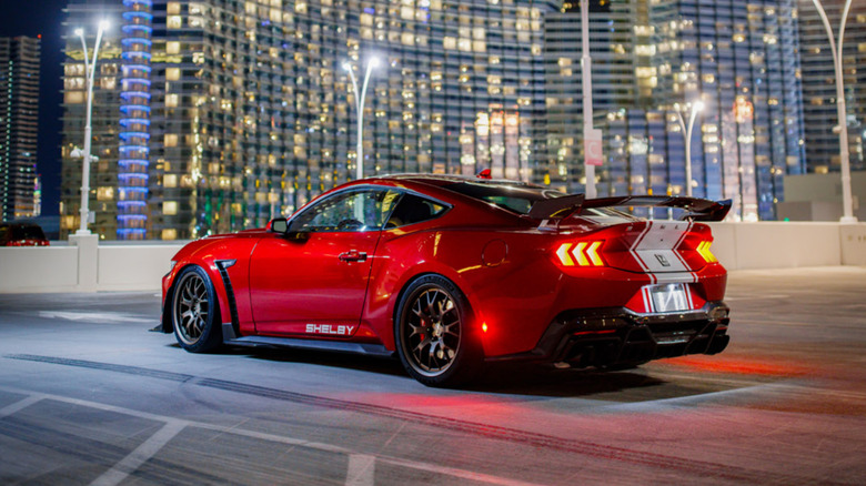 Rear quarter shot of a red Shelby Mustang Super Snake against a city backdrop
