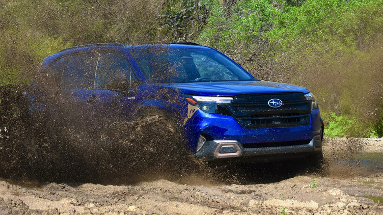 2025 Subaru Forester Hybrid driving through mud.