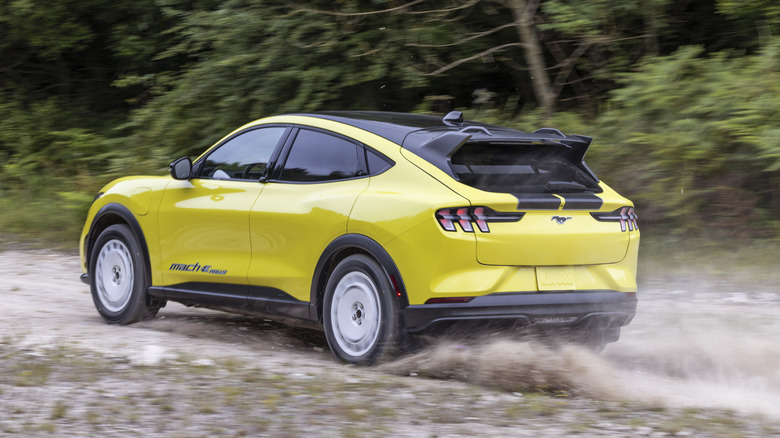 Yellow Ford Mustang Mach-E Rally on dirt trail