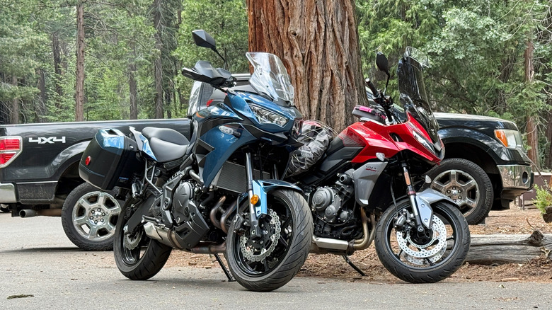 2026 Kawasaki Versys 650 parked next to a Triumph Tiger
