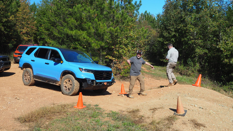 Honda senior engineer Pete Langseth (center) demonstrates part of the obstacle course in front of a modified Honda PIlot