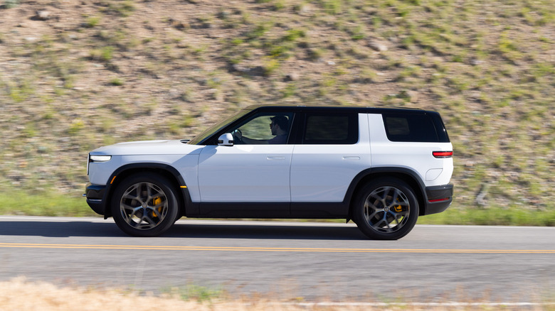 2027 Rivian R2 driving fast motion blur