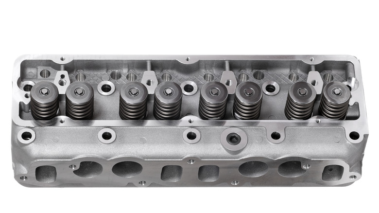 Two-valve cylinder head with four cylinders for eight total valves, isolated on white background