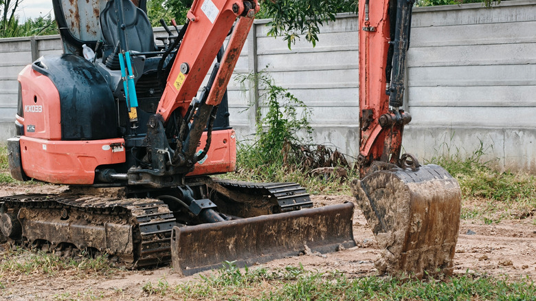 A small red backhoe at work