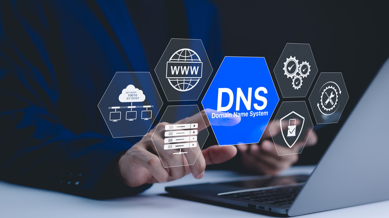 Man using laptop with virtual icons related to DNS.
