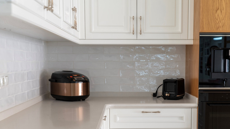 Cooker and toaster on kitchen counter
