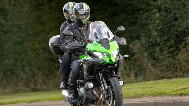 Kawasaki KLZ 1000 CNSNN motorcycle with rider and pillion passenger on an English country road.