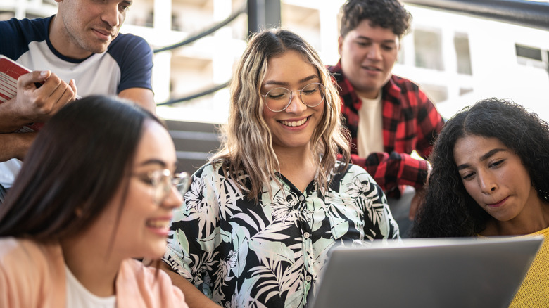 Group of students around computer.