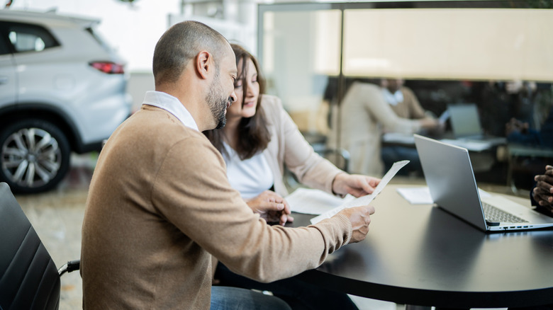 couple reviewing car paperwork