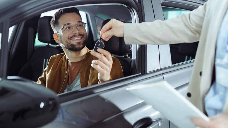 Man with new car