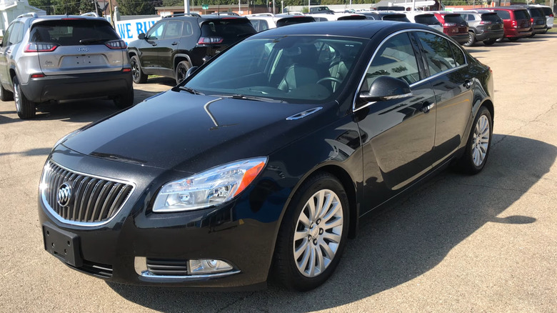 A black 2013 Buick Regal parked in a lot
