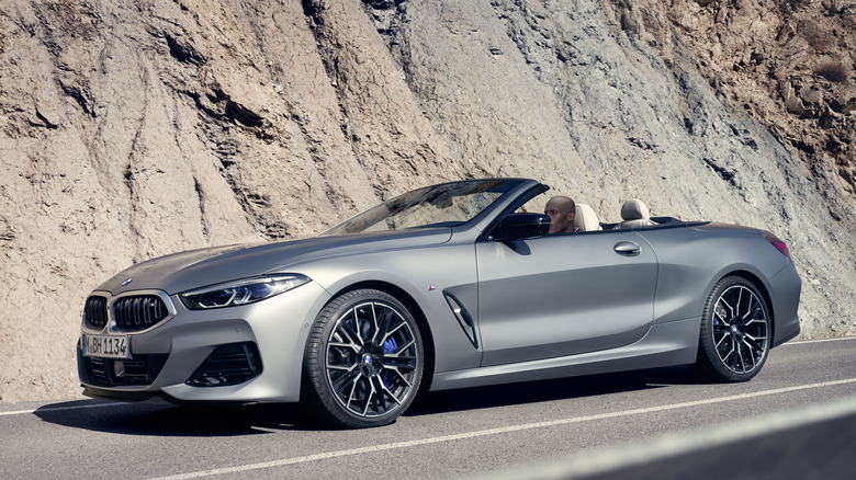 Front 3/4 view of BMW 8 series convertible with mountains in background