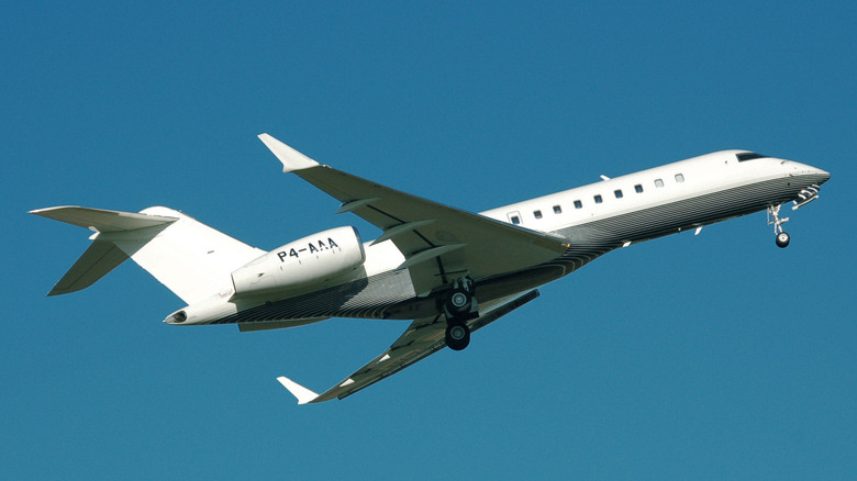 Bombardier Global Express business jet (with Aruba registration P4-AAA) climbs away from London Luton Airport, England