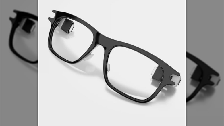 Black-framed smart glasses on a white background