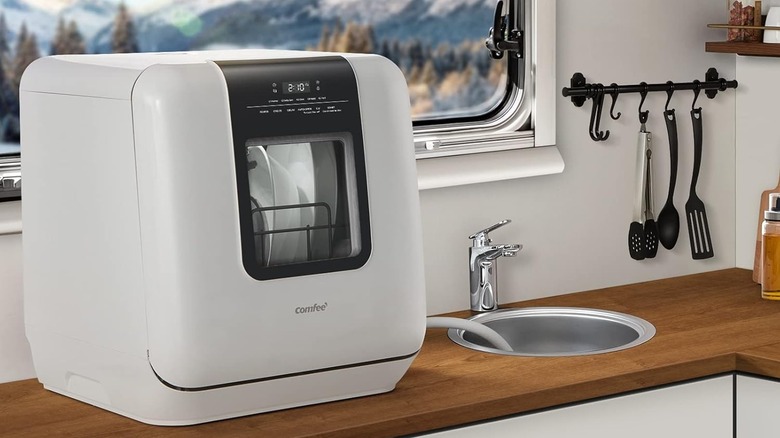 A Comfee dishwasher sitting on the counter in an RV