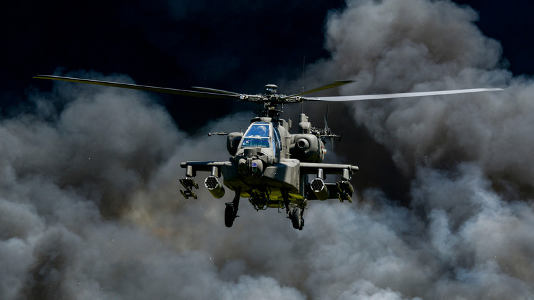 Apache helicopter emerging from smoke
