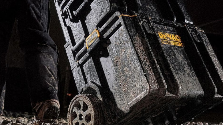 The DeWalt ToughSystem 2.0 Mobile Tool Box carried through mud.