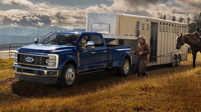The 2026 Ford F-450 Super Duty towing a large horse trailer.