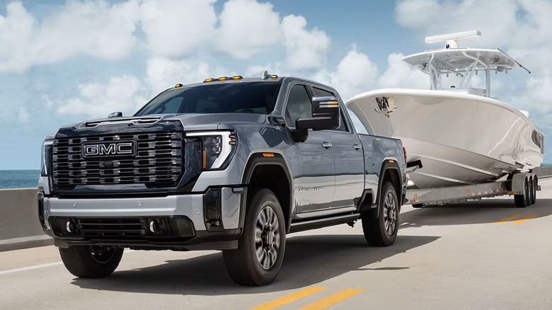 The GMC Sierra HD pickup towing a large boat.