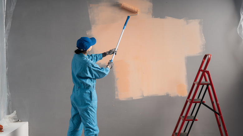 Person painting indoor walls