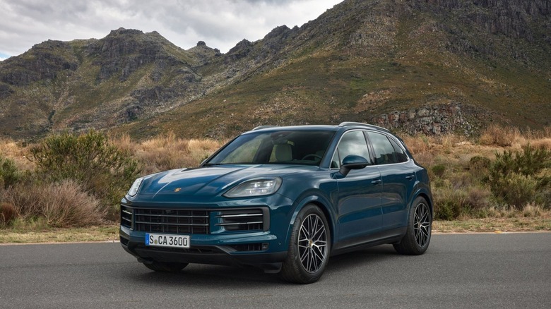 A Porsche Cayenne with mountains in the background