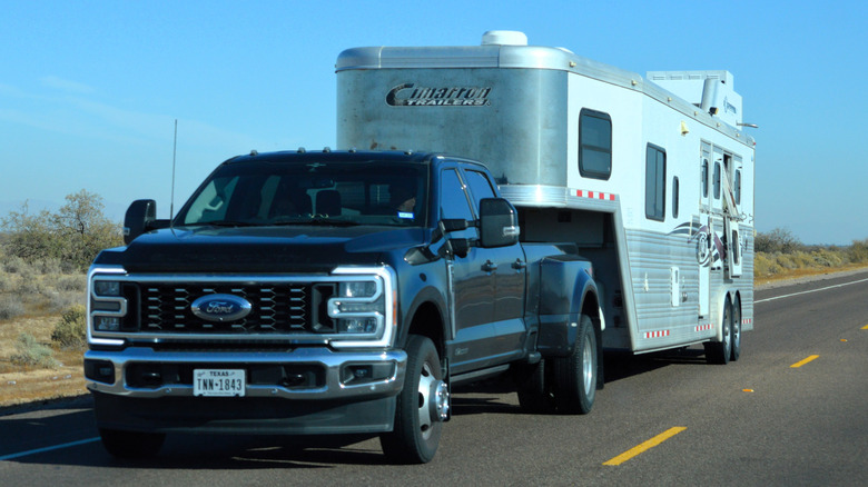 A Ford Super-Duty pickup towing a large trailer