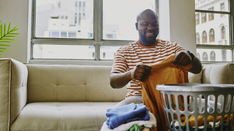 man sorting through laundry