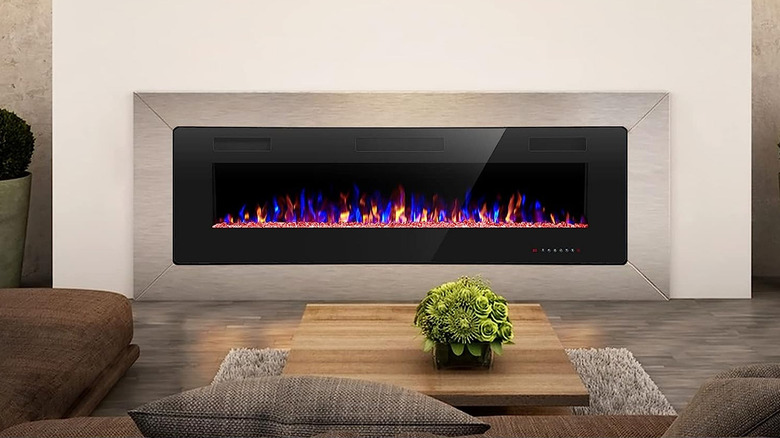 electric fireplace on wall in front of couch