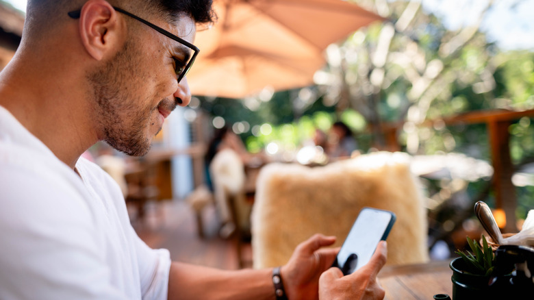 man using phone outdoors