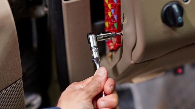 Person using ICON ratcheting socket wrench